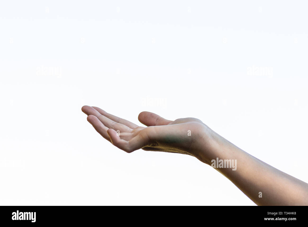 Hand reaching out against white background Stock Photo