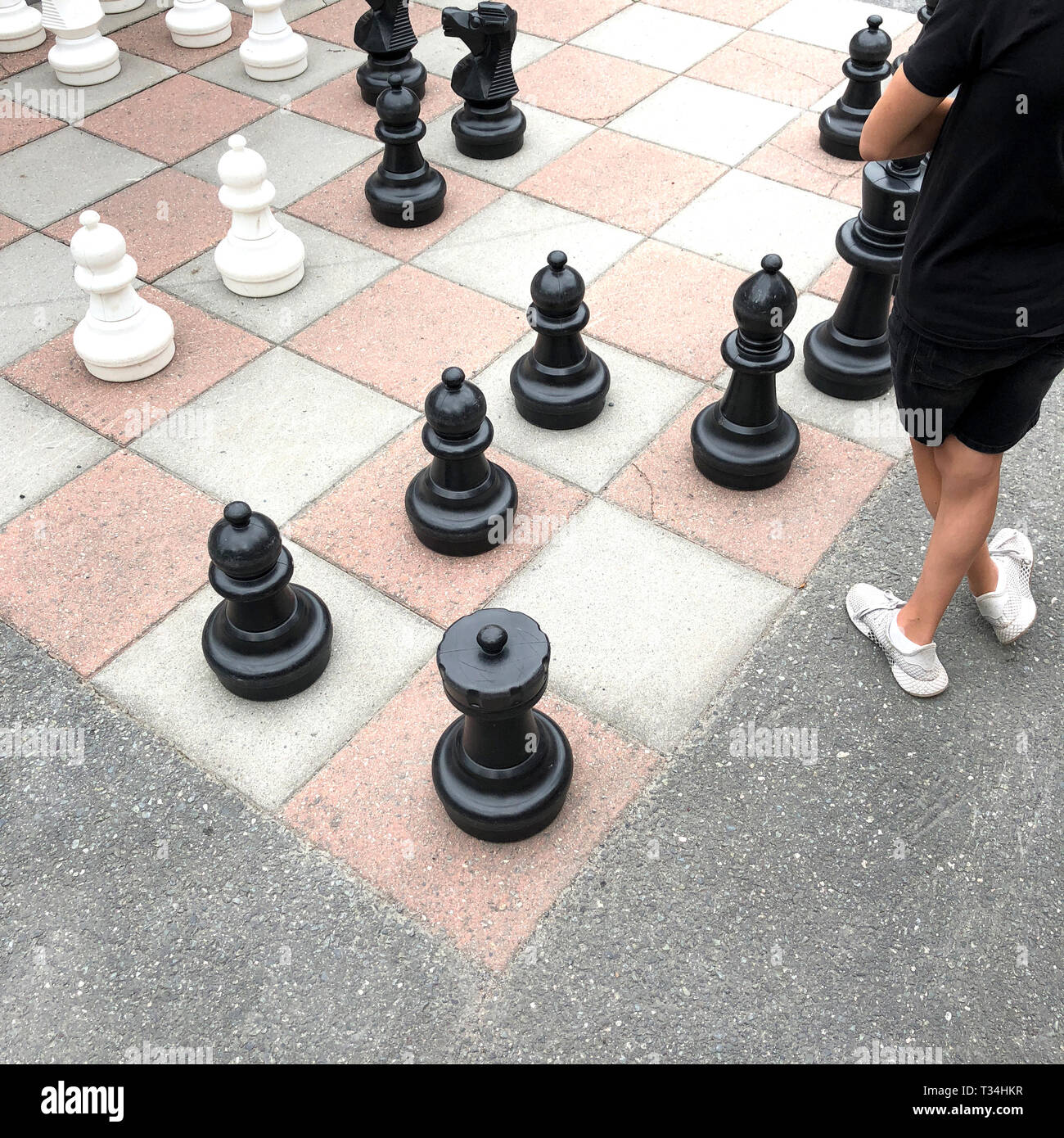 Boy playing a game of giant chess, Baerums Verk, Baerum, Akershus, Norway Stock Photo