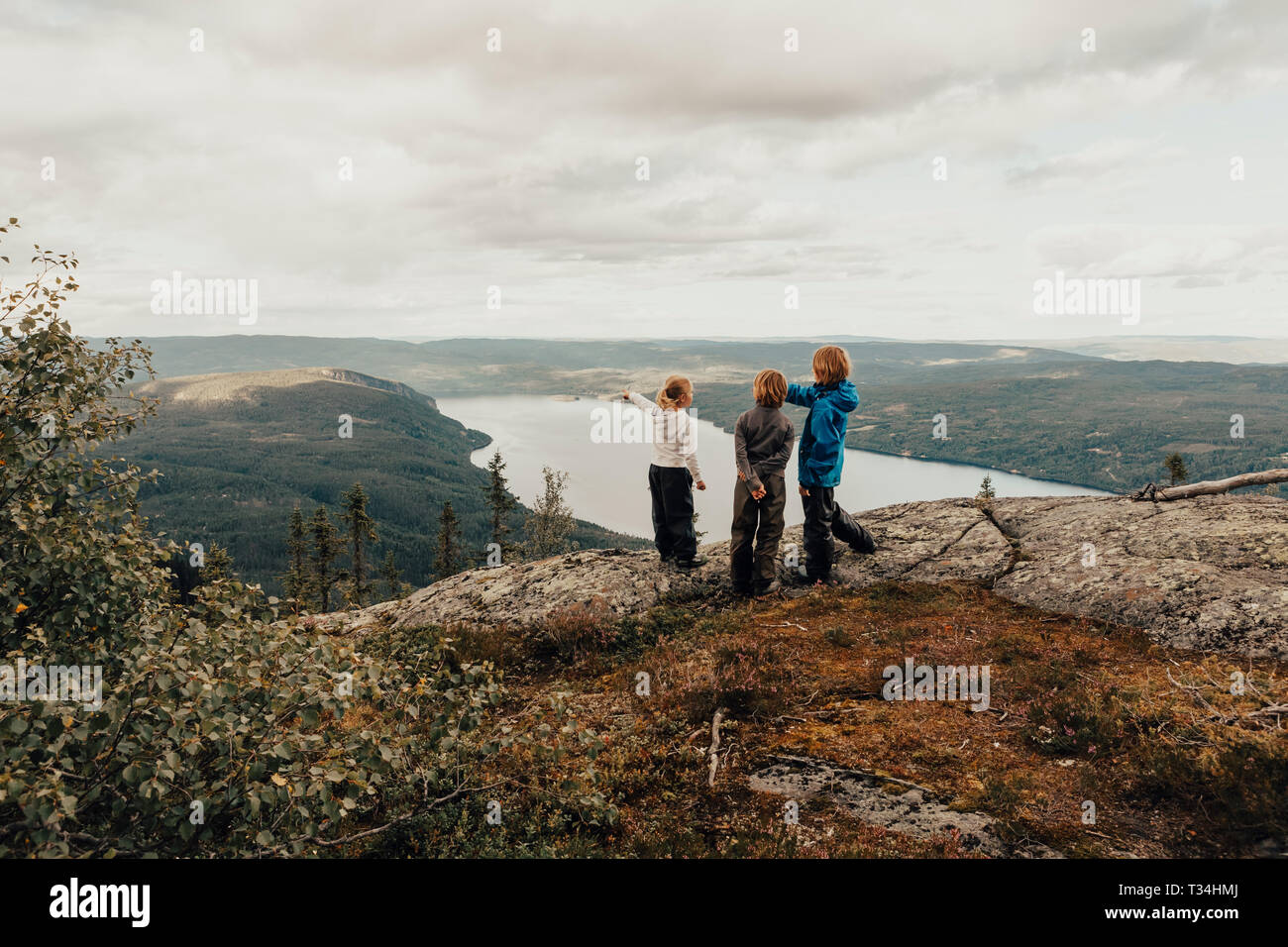 Three children hiking to Vikerfjell, Norway Stock Photo