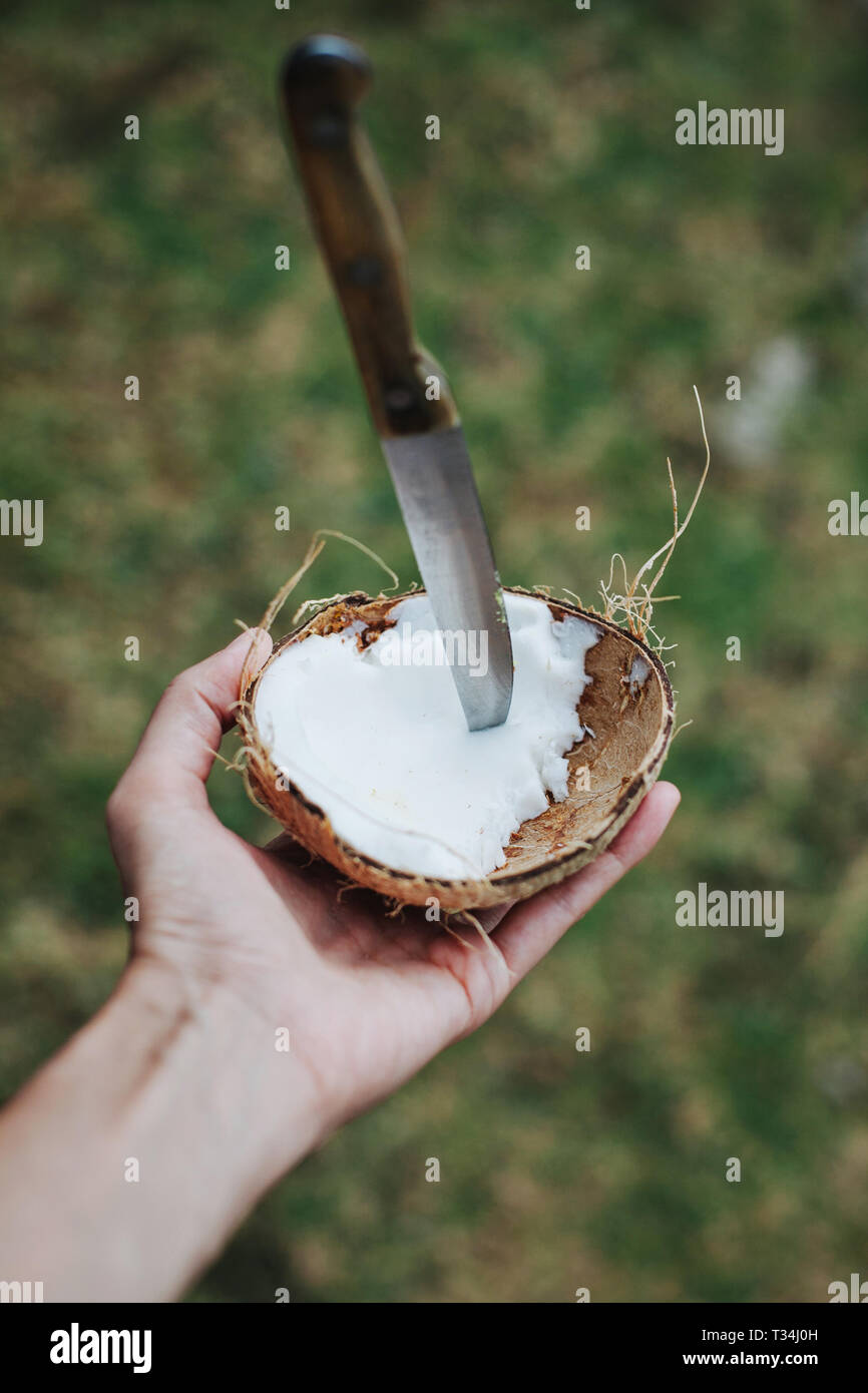Man cutting open a coconut, Seychelles Stock Photo Alamy
