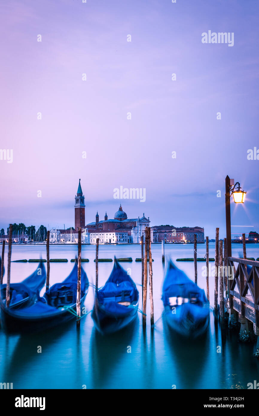 Gondolas moored on a canal, Venice, Veneto, Italy Stock Photo