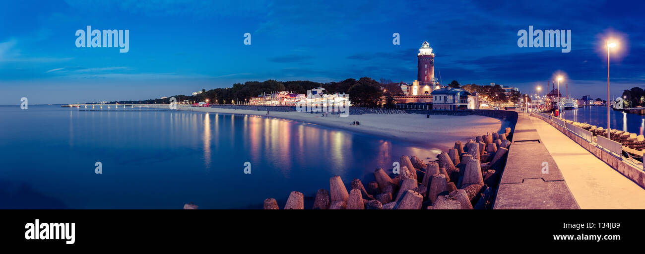 Kolobrzeg lighthouse and promenade along coastline at night, Kolobrzeg, Poland Stock Photo