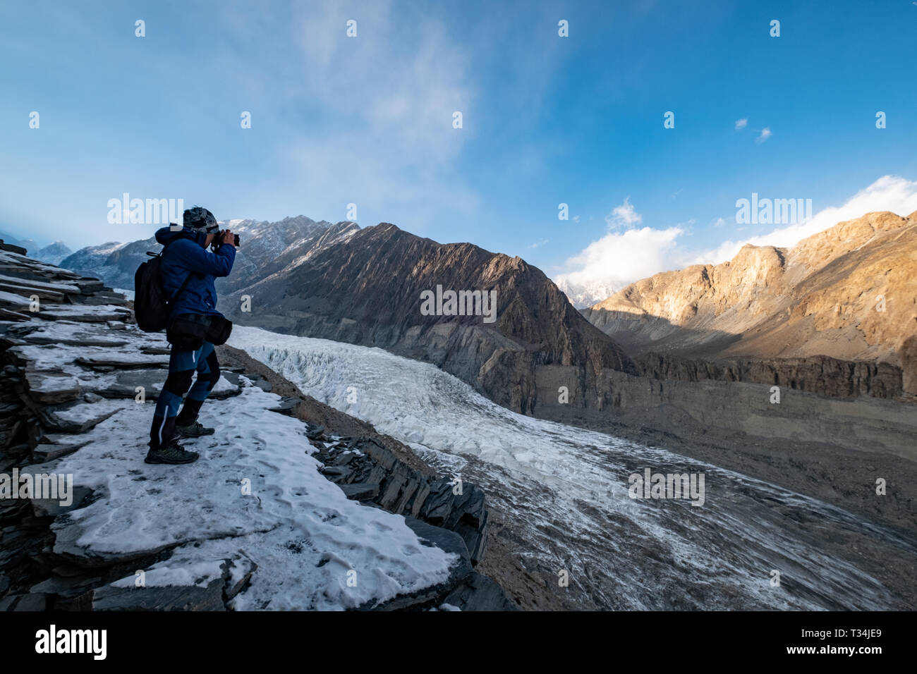 Man photographing the Passu Glacier, Gilgit-Baltistan, Pakistan Stock Photo