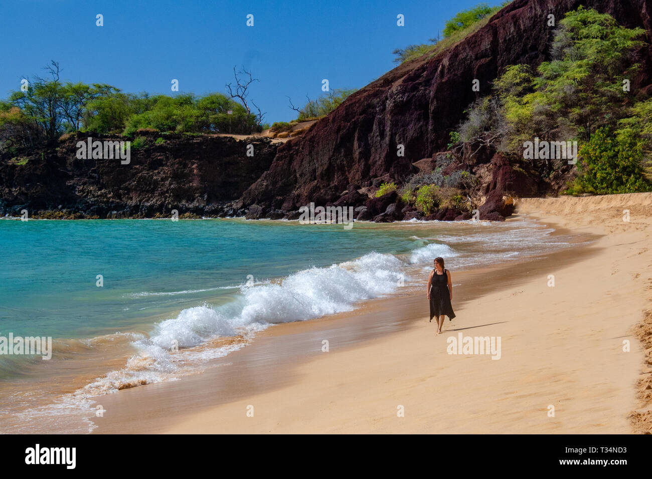 Woman walking along beach, Maui, Hawaii, United States Stock Photo