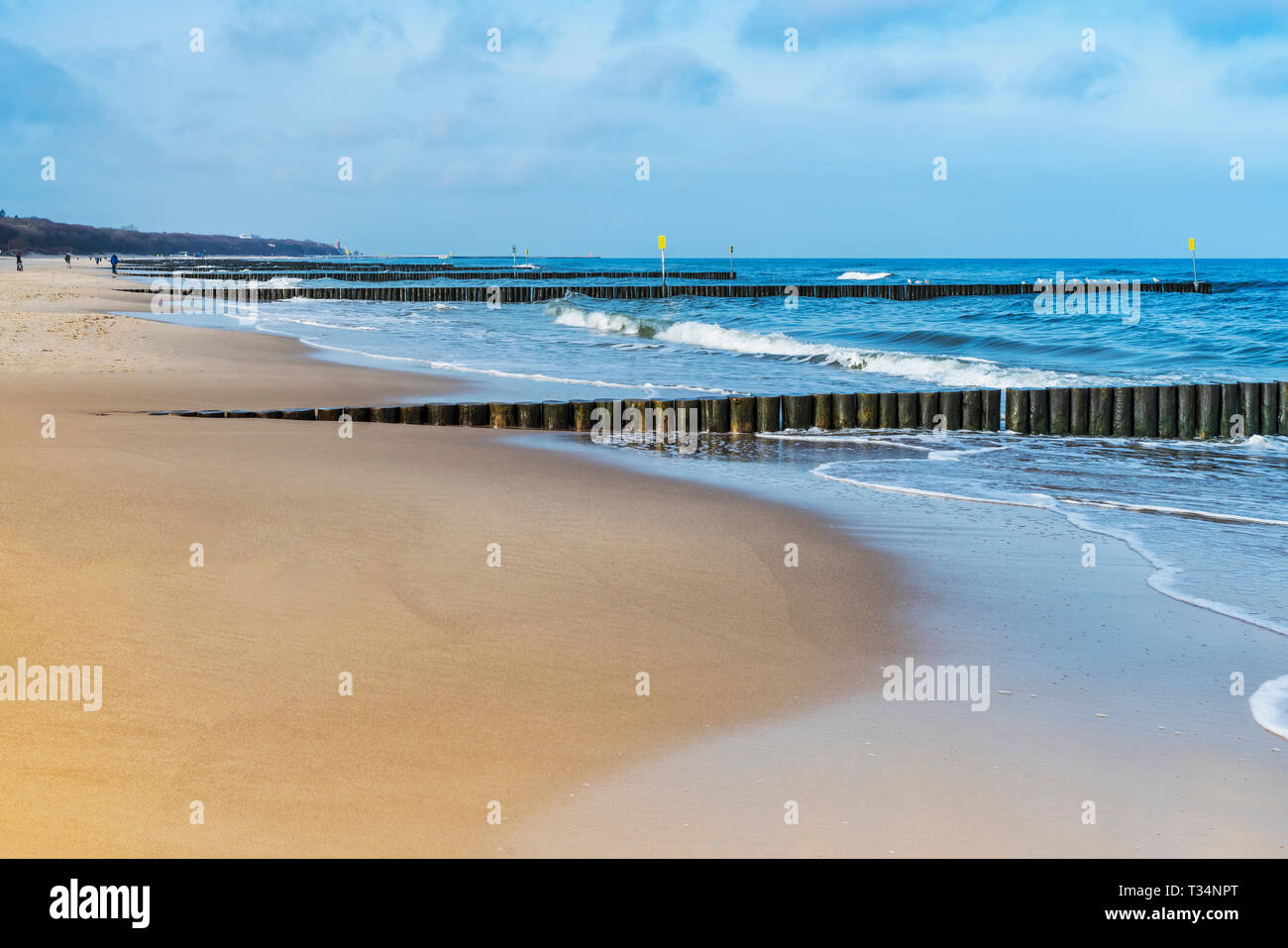 Sandy Beach with groynes on the Baltic Sea, Kolobrzeg, West Pomeranian, Poland, Europe Stock Photo