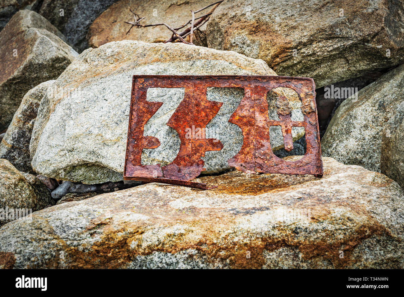 A rusted signpost with the number 330 stands on stones. The Sign is located on the Beach of the Baltic Sea in Kolobrzeg,West Pomeranian, Poland, Europ Stock Photo