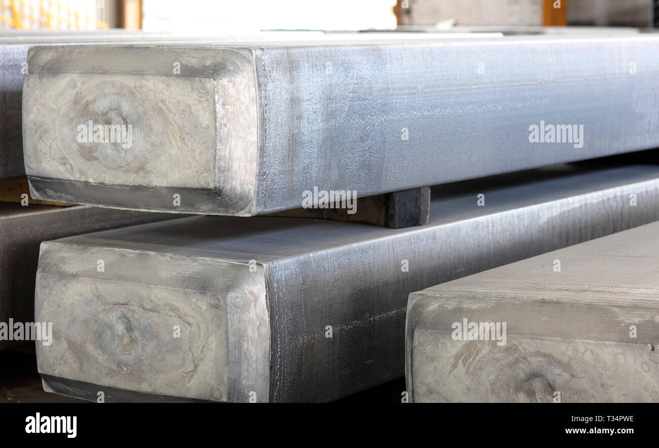 heavy aluminum slabs stacked in a warehouse foundry, raw material to be processed in a hot mill Stock Photo