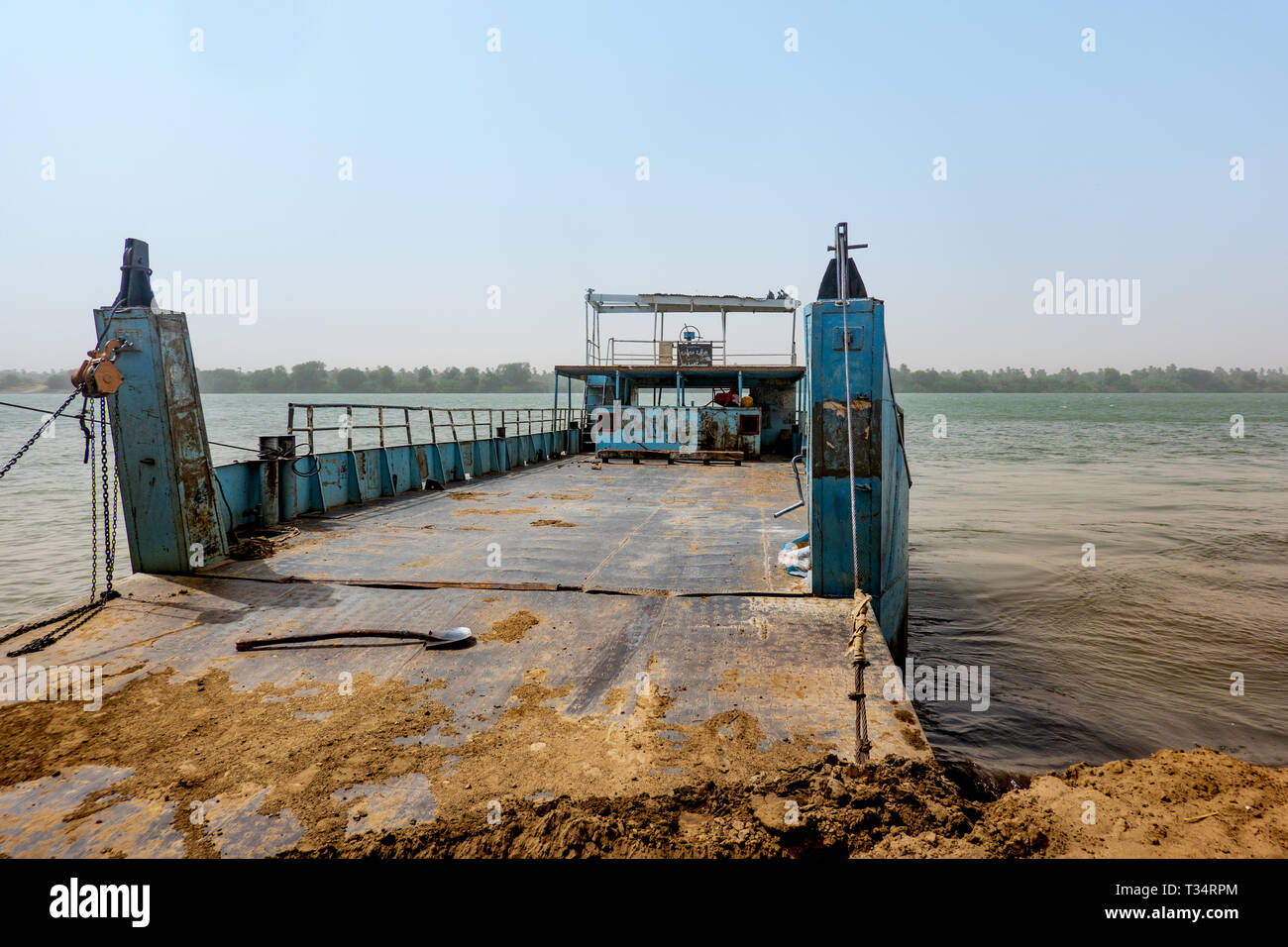 Dongola, Sudan, February 7., 2019: Old battered Nile ferry with blue flaking paint on the banks of the Nile in Sudan Stock Photo
