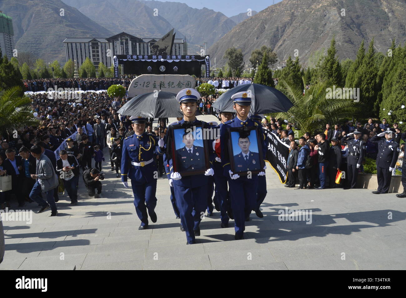 Longnan, China's Gansu Province. 6th Apr, 2019. A ceremony is held to receive the bone ashes of firemen Guo Qi and Wang Fojun, who died while fighting a forest fire in southwest China's Sichuan Province, in Longnan, northwest China's Gansu Province, April 6, 2019. The bone ashes of firemen Guo Qi and Wang Fojun returned to their hometown of Longnan in Gansu Province on Saturday. Credit: Zhang Fan/Xinhua/Alamy Live News Stock Photo