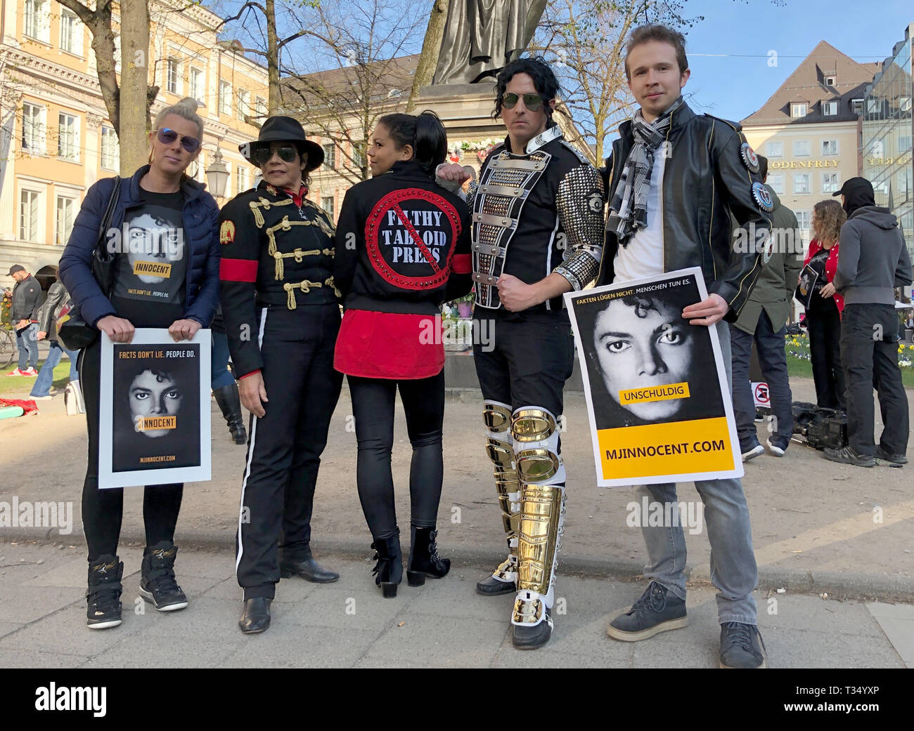 Munich, Germany. 06 April 2019, Bavaria, München: Fans of the 'King of Pop', Michael Jackson, and fans with posters with the inscription 'Innocent' ('innocent') stand in front of the monument to Orlando-di-Lasso, a Renaissance composer and Kapellmeister, which was converted into a Michael Jackson monument in front of the Bavarian Court. They demonstrate against the broadcast of the documentary 'Leaving Neverland' about the pop star Michael Jackson on 06.04.2019 on ProSieben. Photo: Valentin Gensch/dpa/Alamy Live News Stock Photo