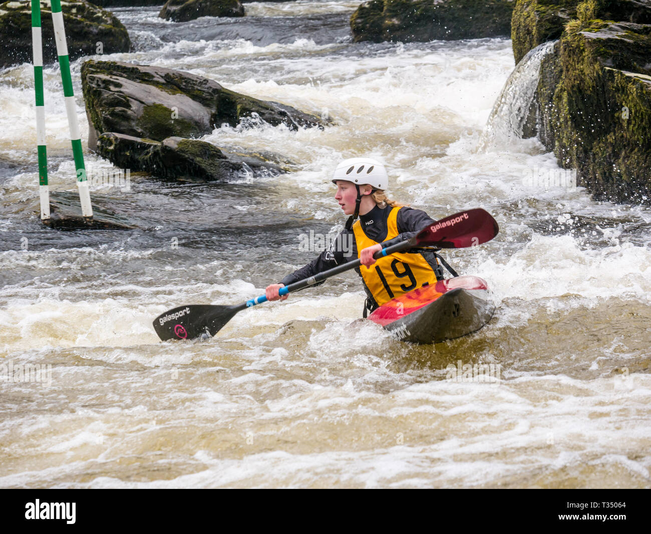 Grandtully, Perthshire, Scotland, United Kingdom, 6 April 2019. Grandtully Premier Canoe Slalom:  Olivia Alderson from Holme Pierrepoint canoe club competes in the women''s premier kayak  on the River Tay Stock Photo