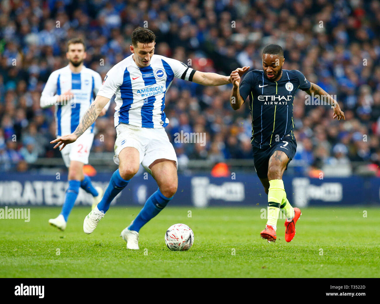 London, United Kingdom. 06th Apr, 2019. L-R Brighton & Hove Albion's Lewis Dunk and Manchester City's Raheem Sterling during The FA Emirates Cup Semi-Final match between Manchester City and Brighton & Hove Albion at Wembley Stadium, London, UK on 06 Apr 2019. Credit: Action Foto Sport/Alamy Live News Stock Photo