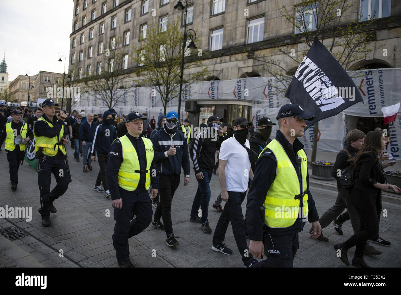 Warsaw, Mazowieckie, Poland. 6th Apr, 2019. Nationalists seen with flags and marching through the streets surrounded by police forces during th protest.''Universities free from Marxism'' a protest against the Warsaw University to express their opposition to the activity of leftist extremists and other cases of left-wing indoctrination of Polish students. In the same place, students, leftist and anti-fascist activists gathered under the slogan ''Here we learn, do not heil''. Both groups were separated by a large police cordon. Credit: Attila Husejnow/SOPA Images/ZUMA Wire/Alamy Live News Stock Photo