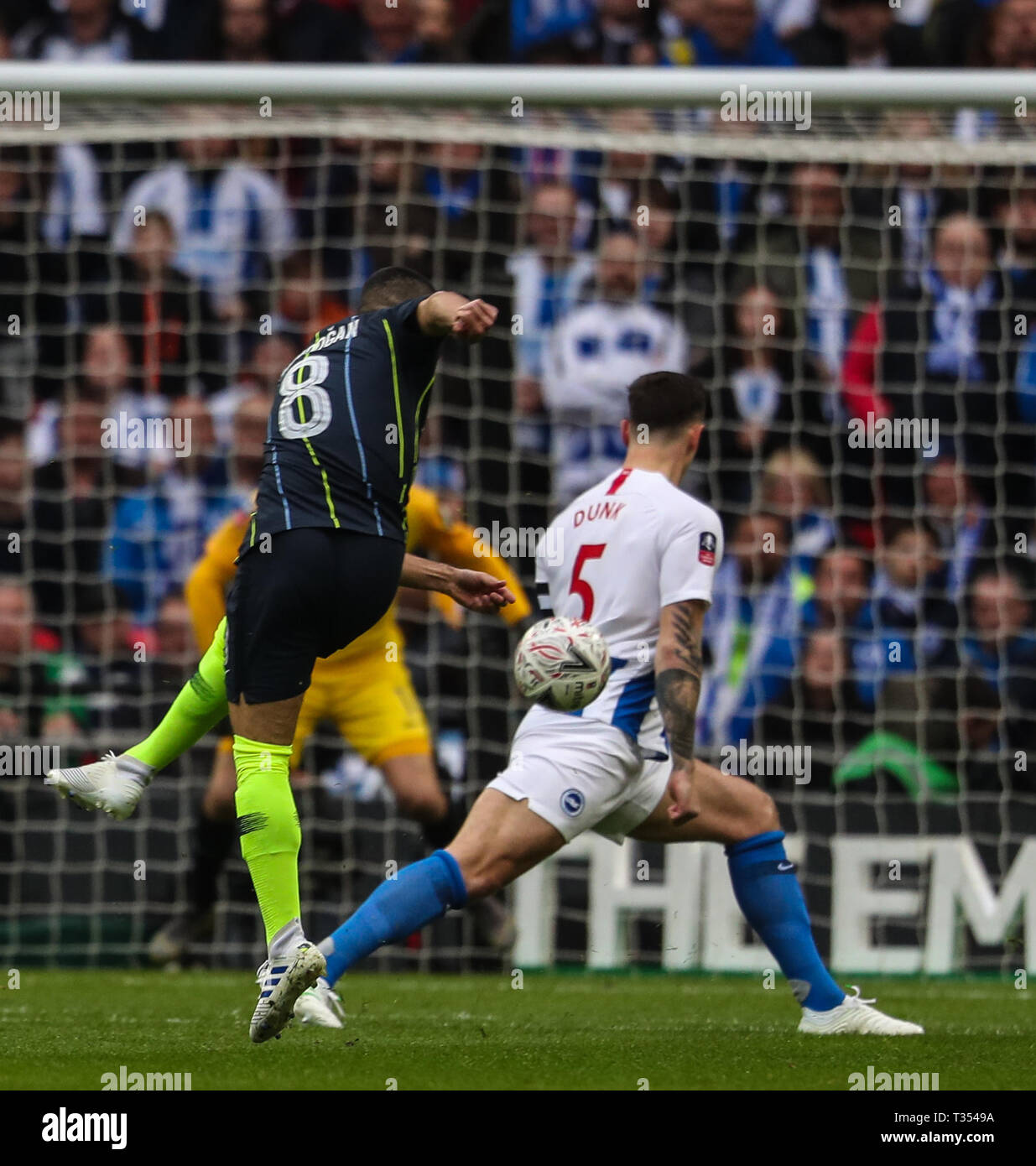 Wembley, London, UK. 06th Apr, 2019. Ilkay Gundogan of Manchester City sees his goalbound strike blocked by Lewis Dunk of Brighton & Hove Albion during the Emirates FA Cup Semi Final match between Manchester City and Brighton & Hove Albion at Wembley Stadium on April 6th 2019 in London, England.  Credit: PHC Images/Alamy Live News Stock Photo