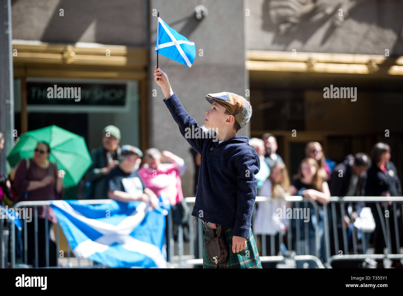New York, USA. 6th Apr, 2019. A boy holds up a Scottish flag during the annual Tartan Day Parade in New York, the United States, on April 6, 2019. The parade, which consists of drummers, pipers and dancers, celebrated Scottish and Scottish American heritage. In 1998 the U.S. Senate declared April 6 to be National Tartan Day to recognize the contributions made by Scottish Americans to the United States. Credit: Michael Nagle/Xinhua/Alamy Live News Stock Photo