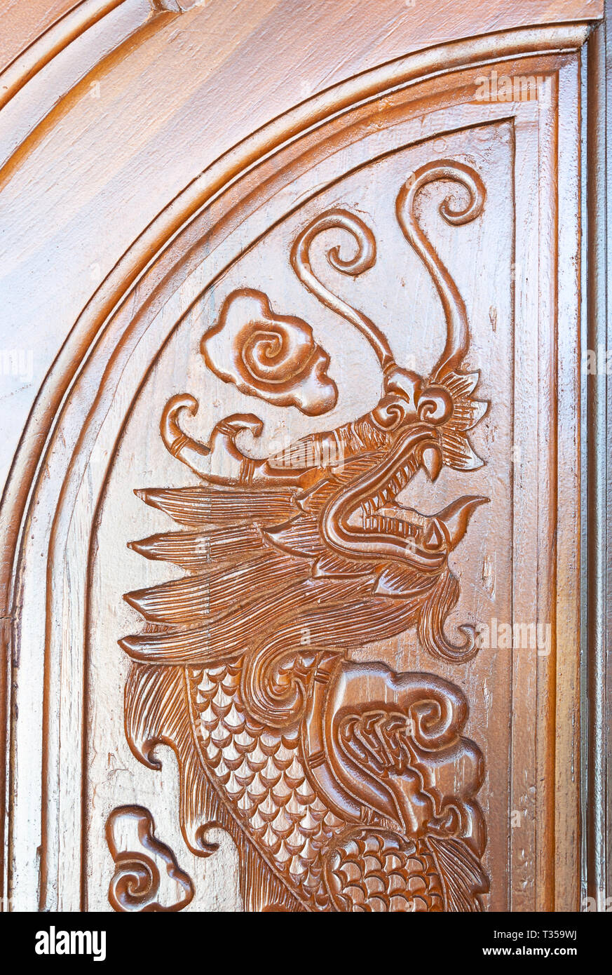 Carved dragon pattern in the traditonal Chinese style on the wooden