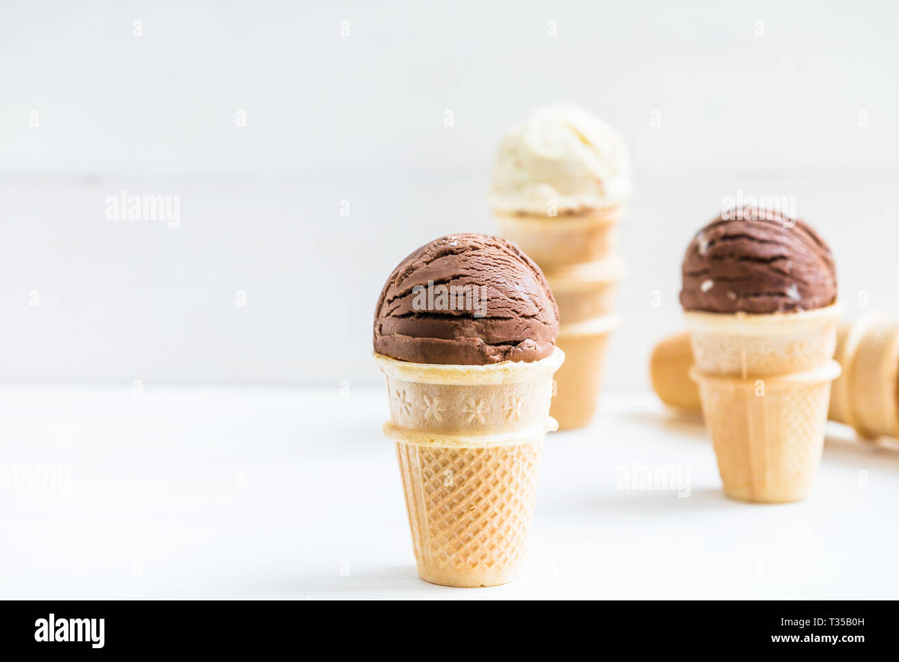 Vanilla and Chocolate Ice Cream Scoops in Waffle Cup Cones on Light ...