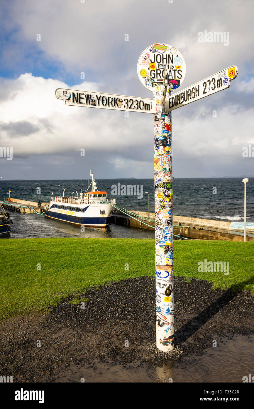 Located in northeast Scotland, the John O'Groats landmark sign points the direction and distance to other cities. Stock Photo