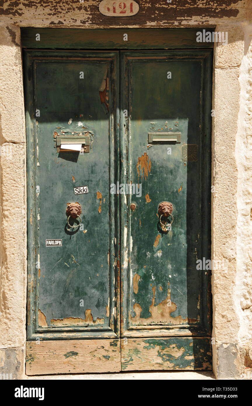 very old door with splintered green varnish mediterranean Stock Photo