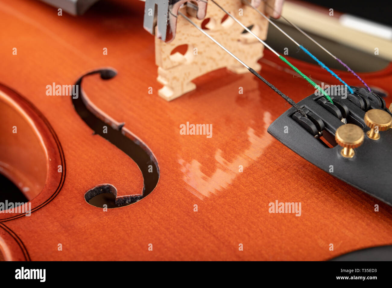 Beautiful new shiny violin on a dark table. Musical string instrument ...