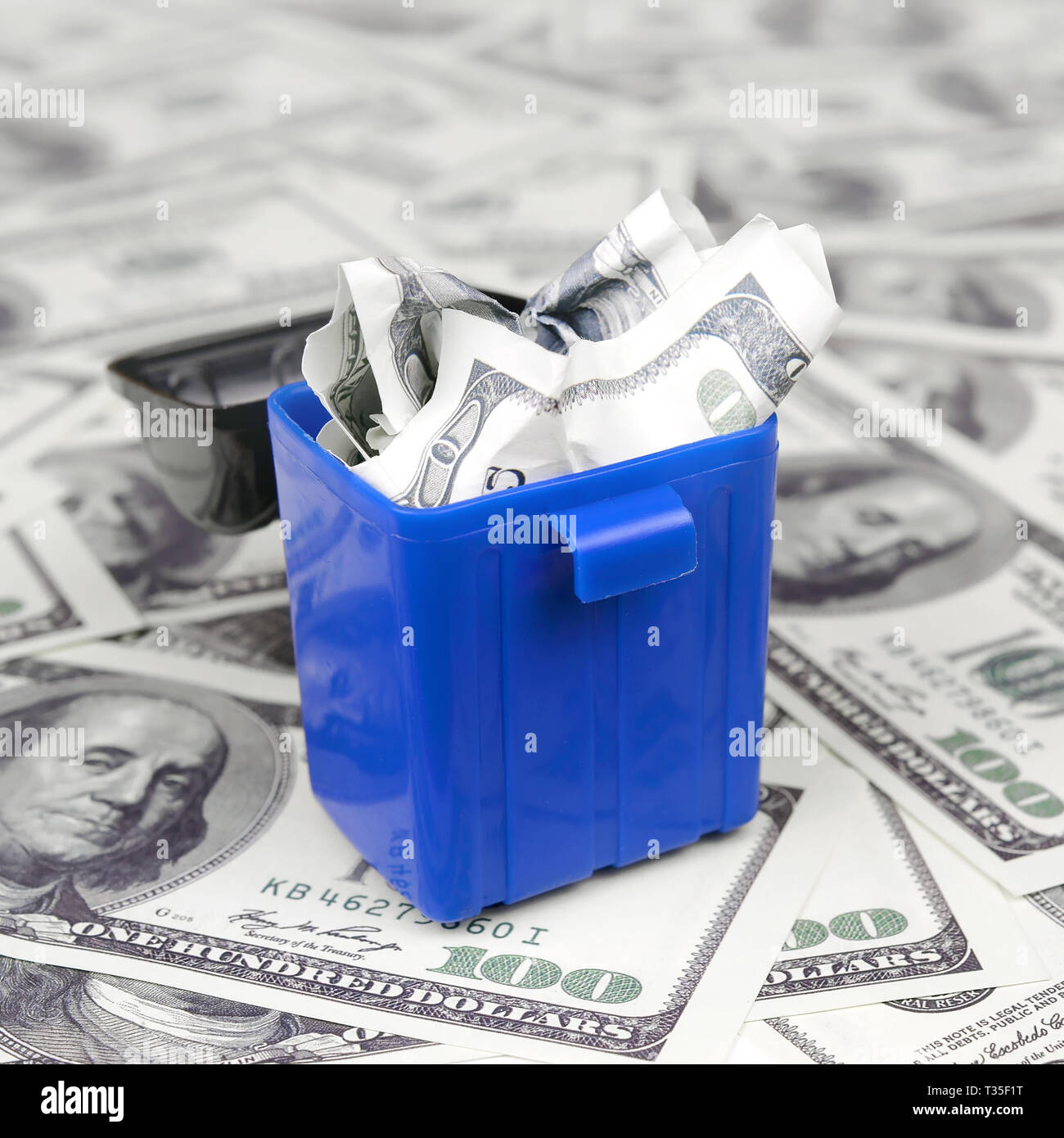 American cash notes are thrown into the trash bin on a multitude of