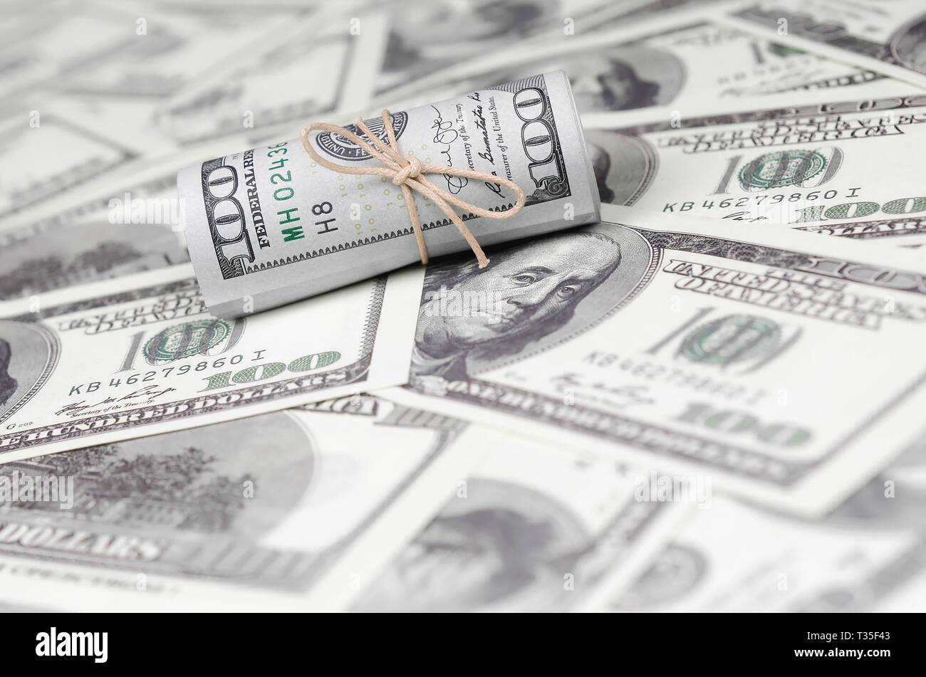 US dollars rolled up and tightened with band lies on a lot of american