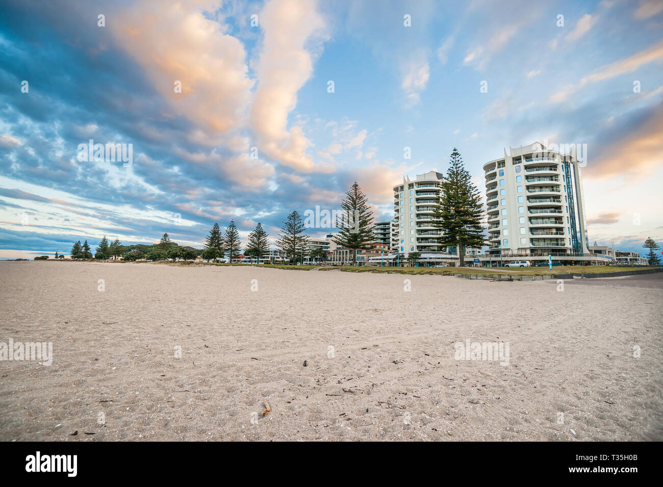 Mount Maunganui twin tower apartment buildings from beach at twilight