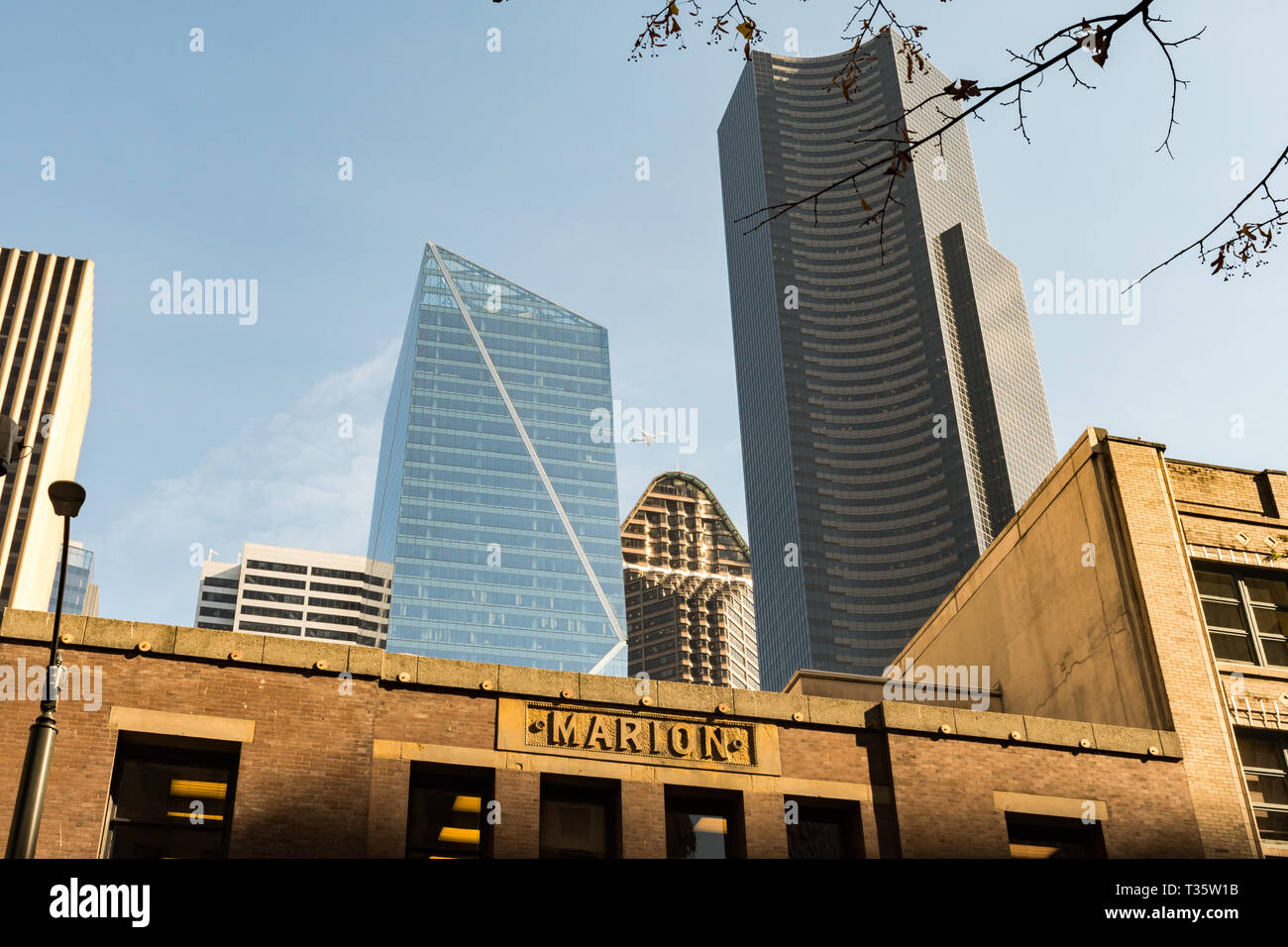 An airplane seen between  The Mark Tower, Columbia Center and Seattle Municipal Tower, Washington, USA. Stock Photo