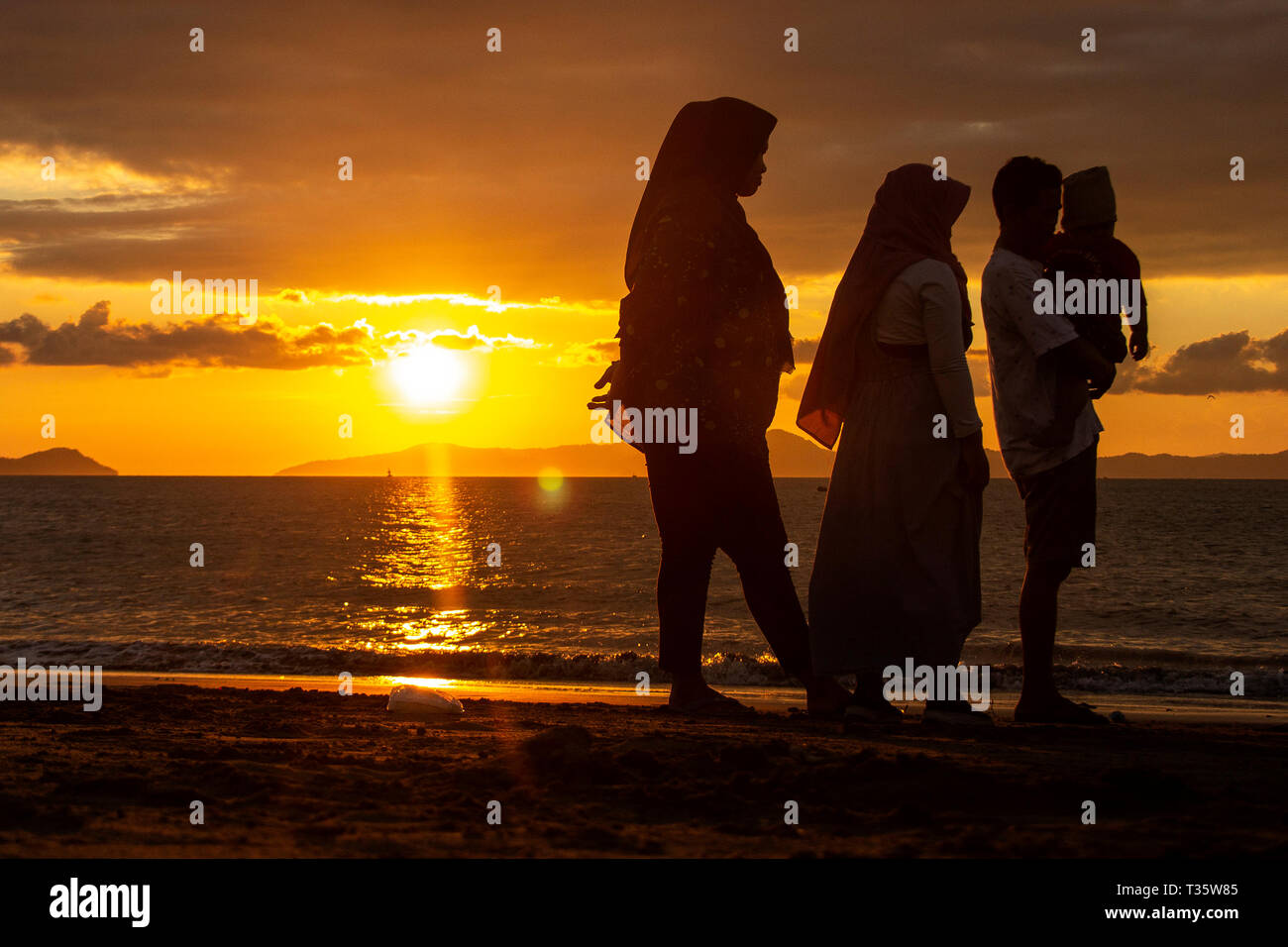 Residents seen enjoying the sunset on the Gampong Jawa beach, Banda Aceh, Indonesia. Stock Photo