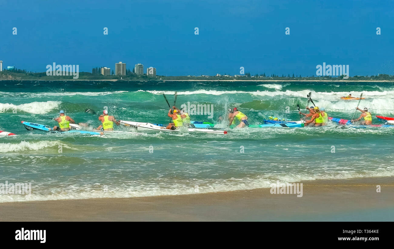 ALEXANDRA HEADLAND, QUEENSLAND, AUSTRALIA- APRIL 24: surf ski race competitors leaving the beach in a race Stock Photo