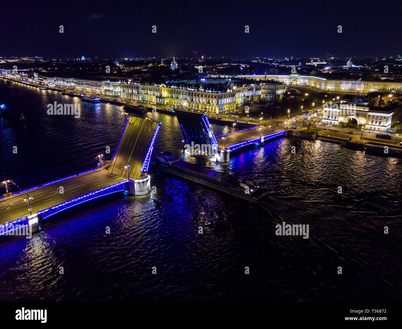 Summer night, Saint Petersburg, Russia. Neva River. A ship passes under drawn bascule moveable Palace bridge. Winter Palace. Admiralty. Palace Square. Stock Photo