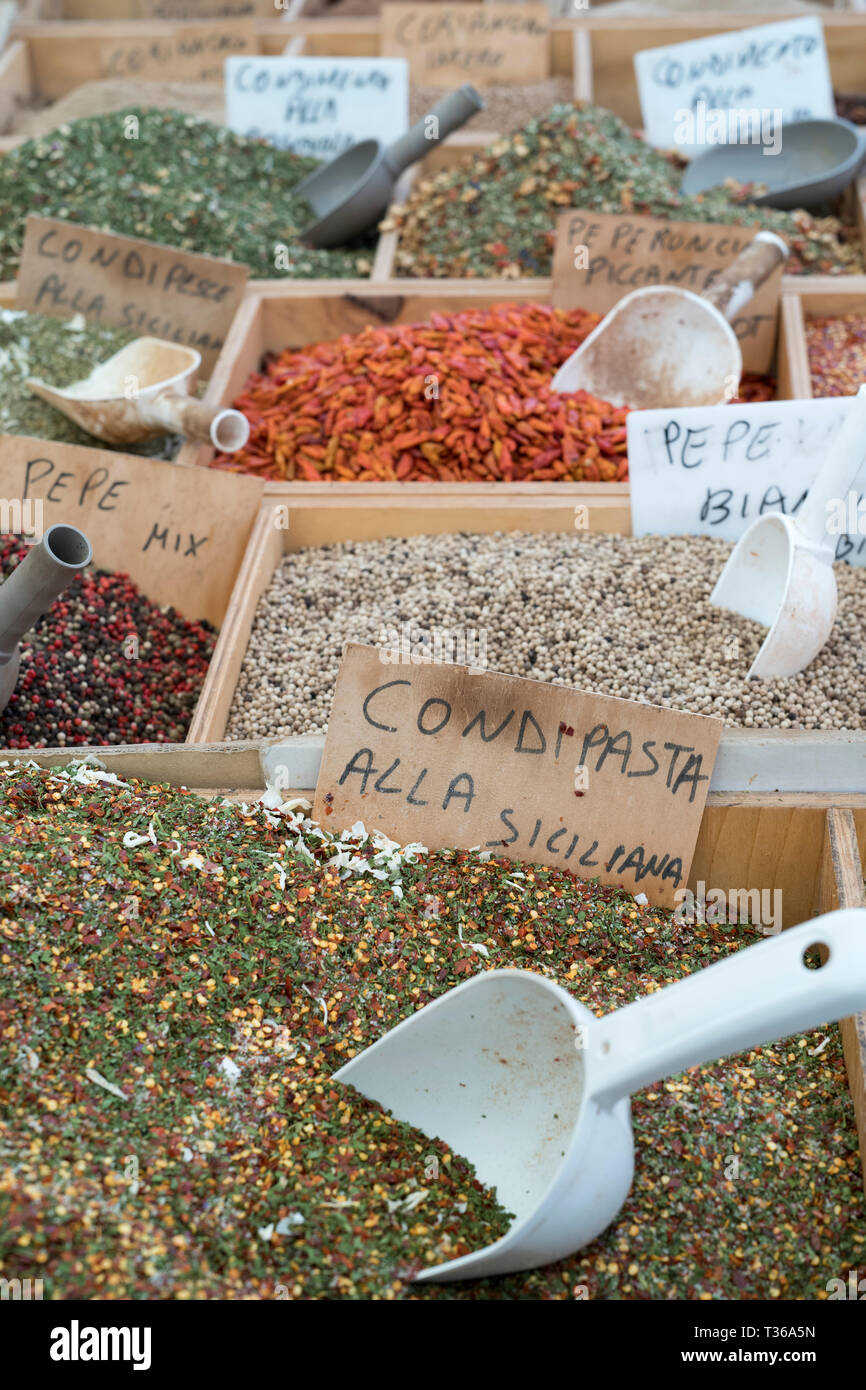 Dried goods, spices and condiments on display for sale on market stall at old street market - Mercado -  in Ortigia, Syracuse, Sicily Stock Photo