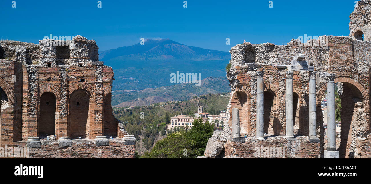 View of Mount Etna volcano from ruins of the ancient Greek Theatre amphitheatre - Teatro Greco - of Taormina, East Sicily, Italy Stock Photo