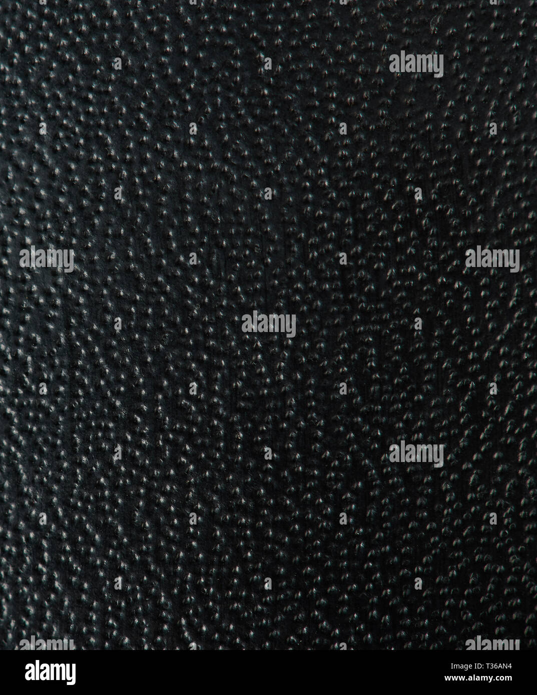 Black dotted leather texture background macro view Stock Photo