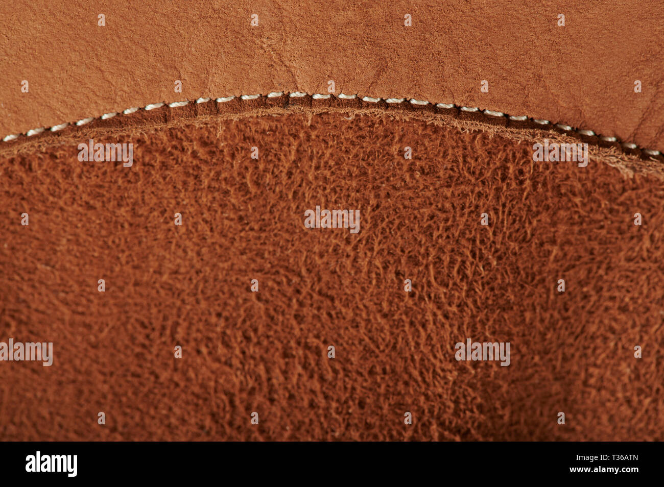 Stitch on brown leather background macro close up view Stock Photo