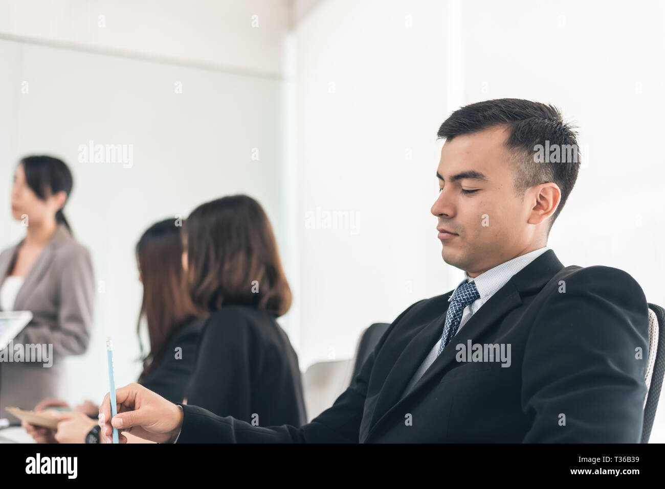 young business man feel boring at meeting Stock Photo