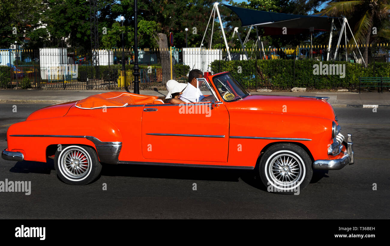 Orange 1952 Chevy Convertible Coupe driving the street in Havana, Cuba Stock Photo