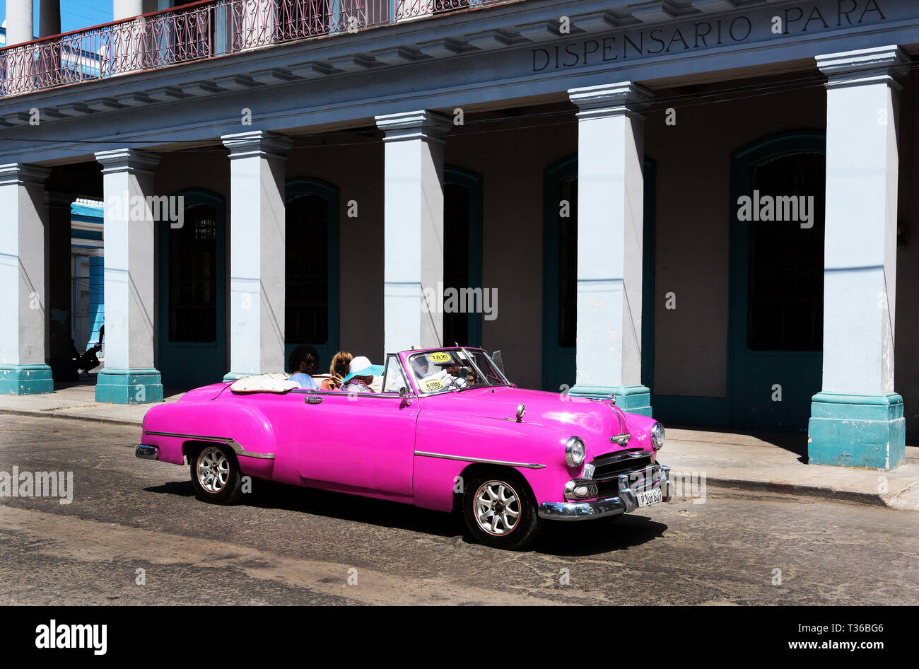 Pink 1951 Chevrolet Cpnvertible driving in Havana, Cuba Stock Photo