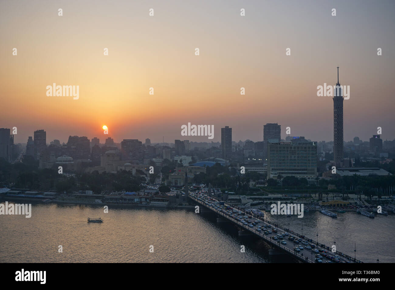Cairo, Egypt: Cairo Tower and the Qasr el Nile Bridge at sunset. On ...