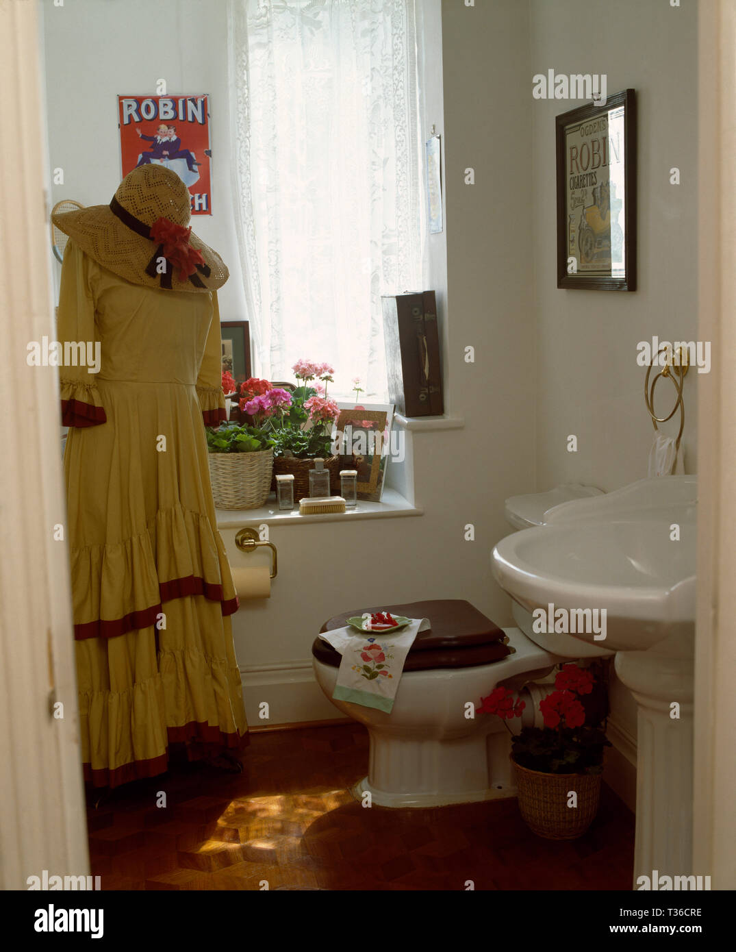 Vintage dress and hat on mannequin in small bathroom Stock Photo - Alamy