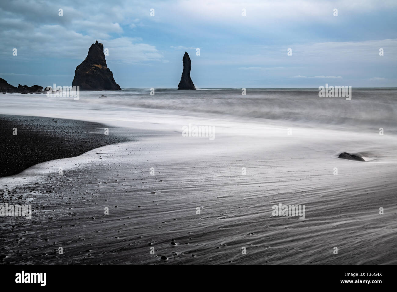 Reynisfjara is a world-famous black-sand beach found on the South Coast of Iceland, just beside the small fishing village of Vik. Stock Photo