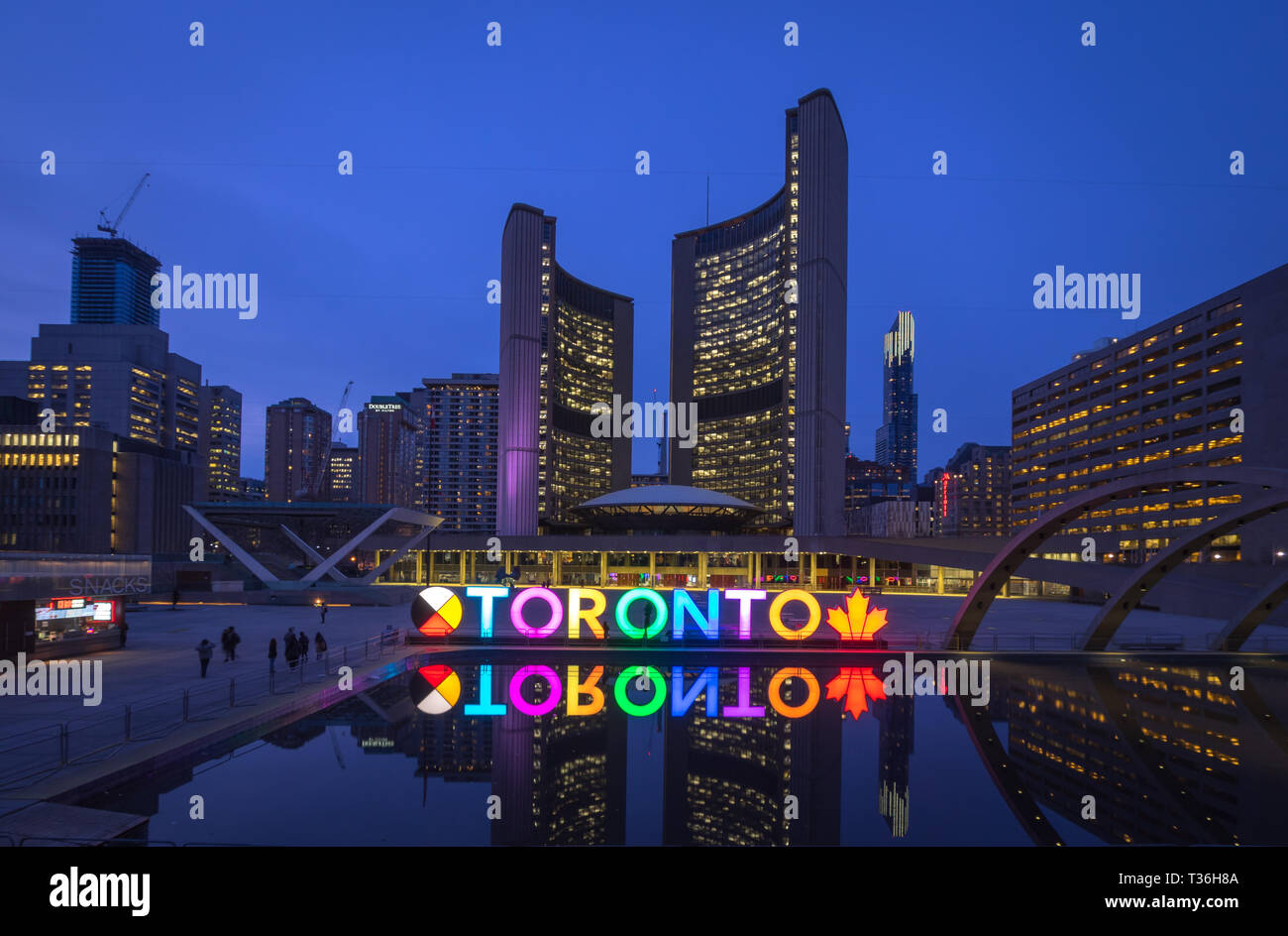 A night view of the 3D TORONTO sign, Toronto City Hall (New City Hall), and Nathan Phillips Square in downtown Toronto, Ontario, Canada. Stock Photo