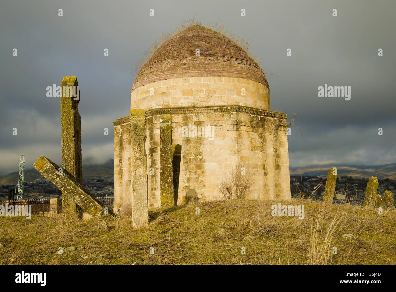 One of the ancient mausoleums of the 'Eddie Gumbez' complex on a cloudy January day. Shemakhi, Azerbaijan Stock Photo