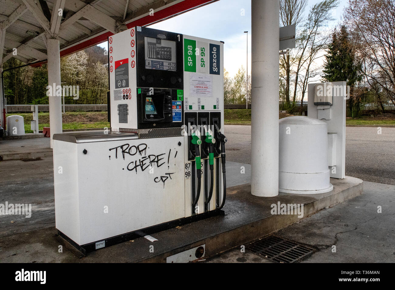 Graffiti on a fuel pump in Albertville reading 'Trop Chere' (in English - too expensive) as protests about the price of fuel continue across france. Stock Photo