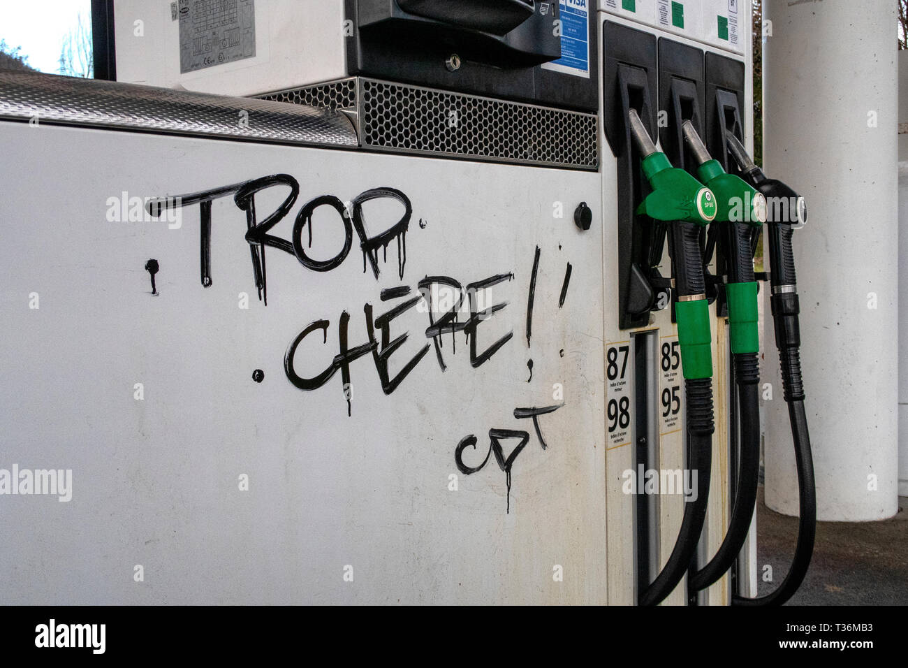 Graffiti on a fuel pump in Albertville reading 'Trop Chere' (in English - too expensive) as protests about the price of fuel continue across france. Stock Photo