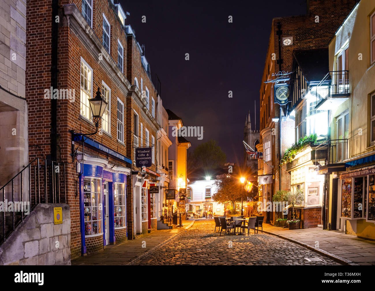 Church Street in Windsor, Berkshire, UK at night. Church Street is a cobbled, pedestrianized street with pubs, restaurants and tourist shops. Stock Photo