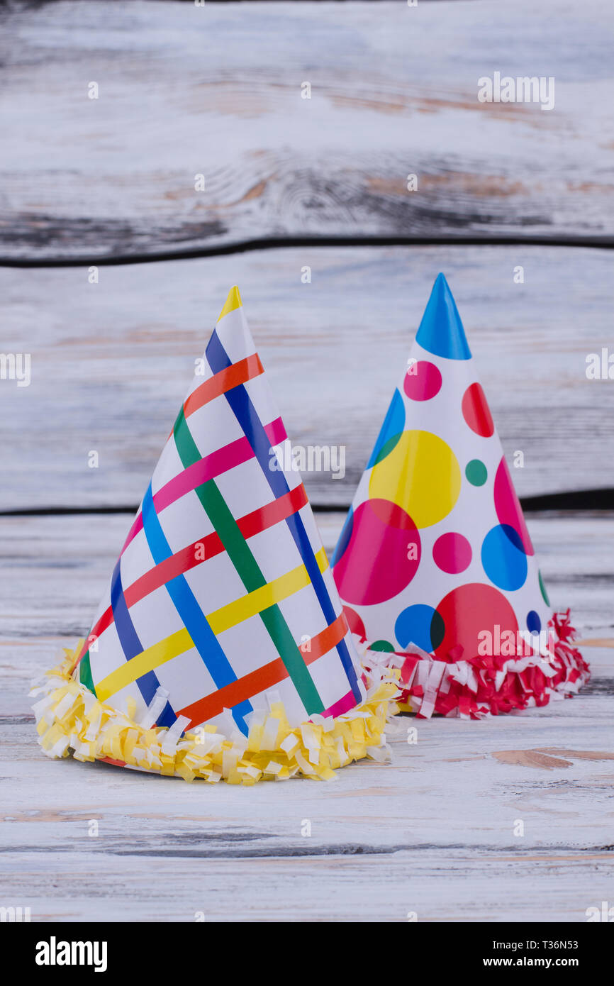 Two kids party hats on wooden background. Funny paper caps for carnival or  party celebration Stock Photo - Alamy