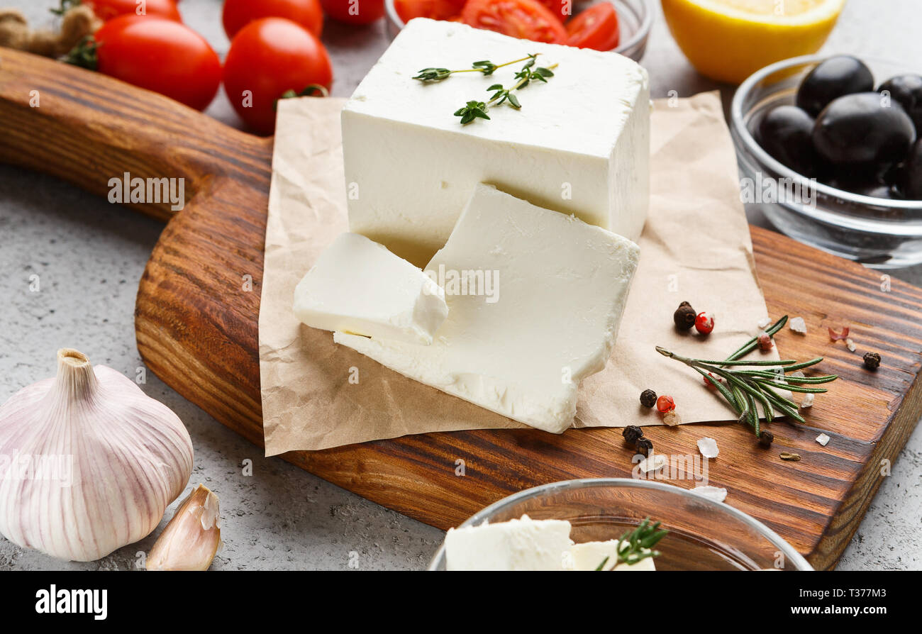 Cubes of feta and spices on board Stock Photo Alamy