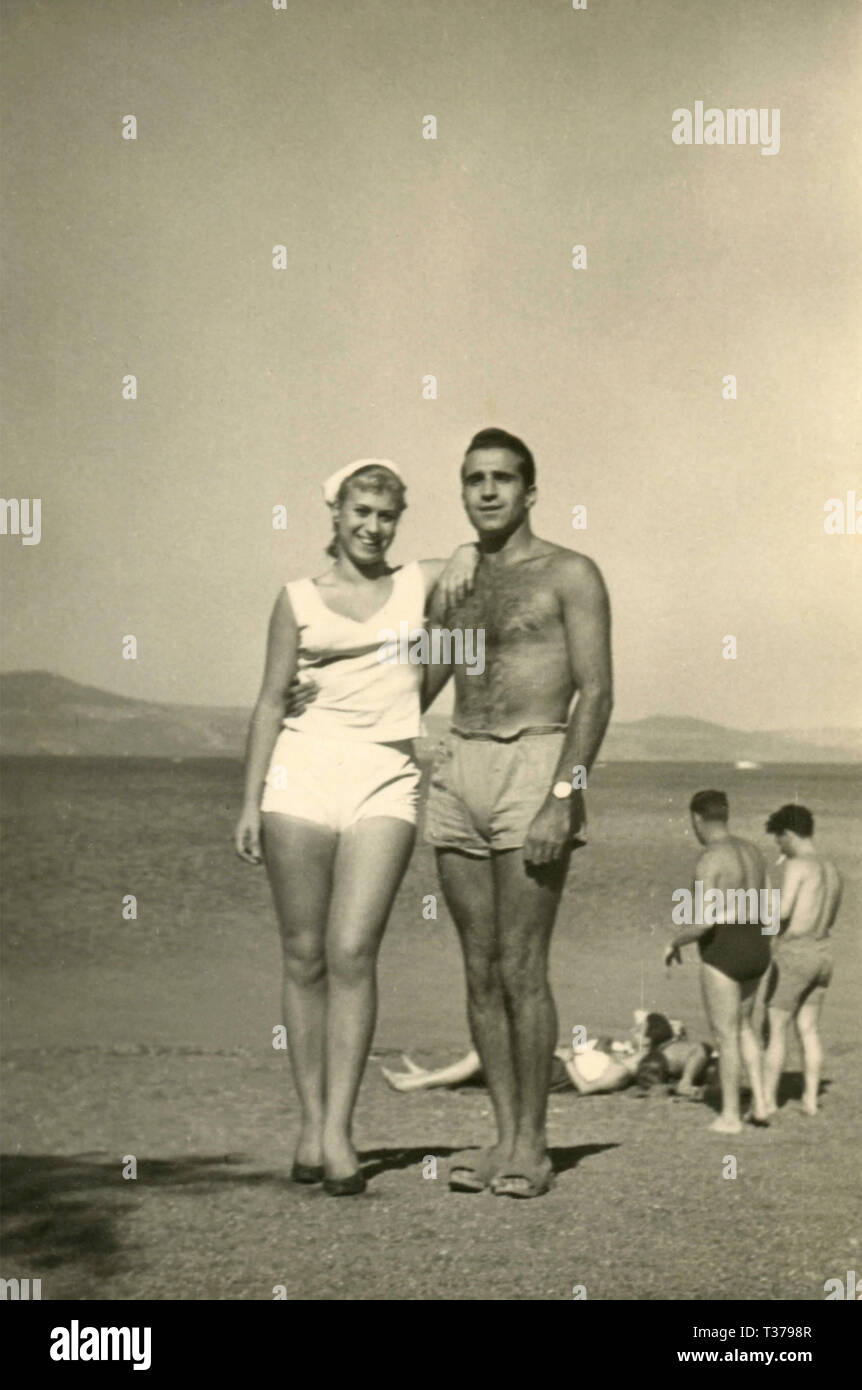 barechested-man-and-woman-at-the-beach-italy-1960s-T3798R.jpg