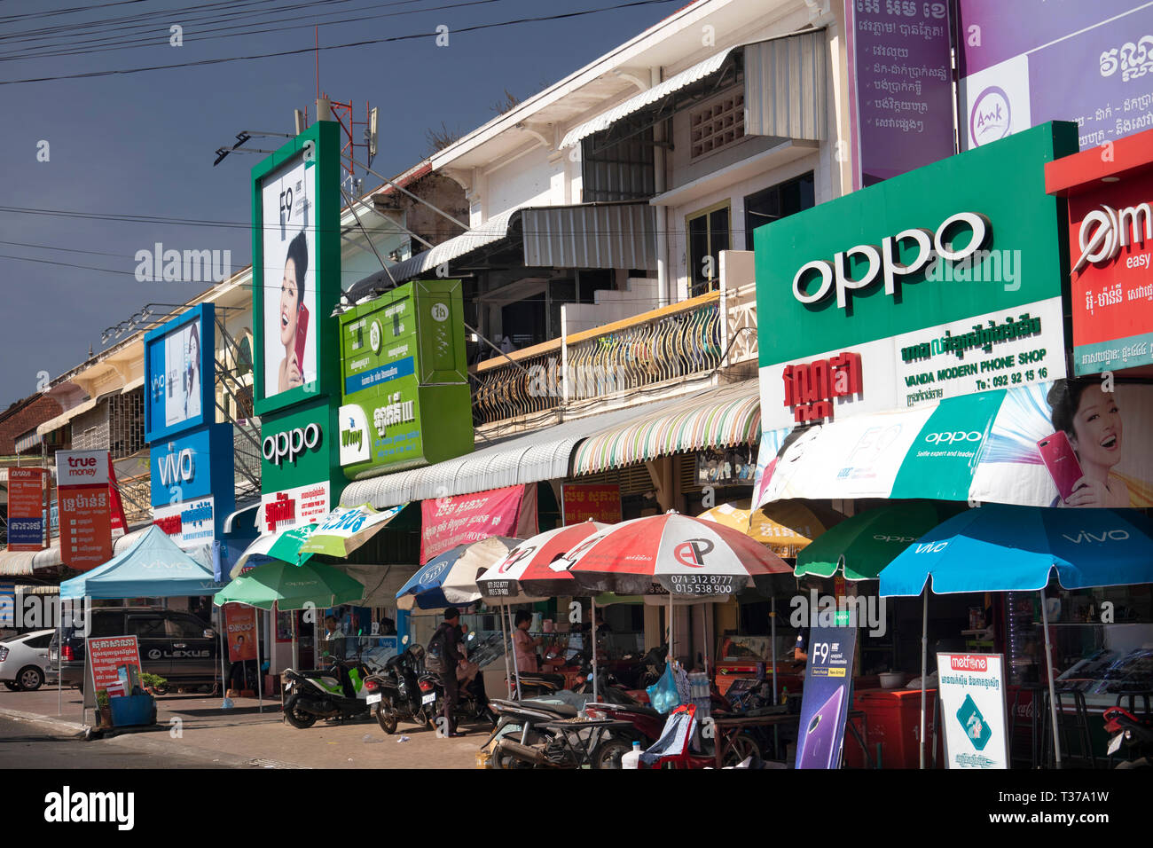 Cambodia, Kampong (Kompong) Cham, town centre, shops in old French colonial buildings covered in signs Stock Photo